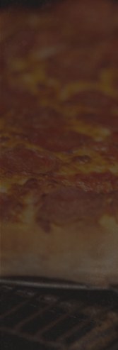 Pizza going into the oven